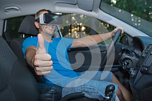 Man with virtual reality glasses sitting in car and showing thumbs up