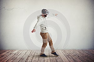 Man in virtual reality glasses stepping carefully