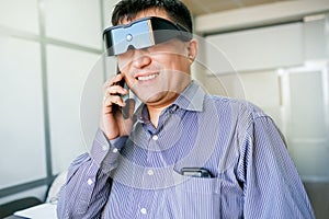 Man in virtual reality glasses talking on phone