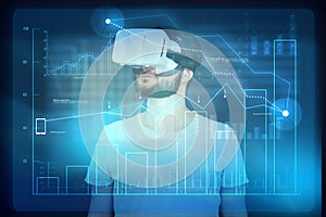 Man in virtual reality glasses using digital monitor with diagram