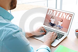 Man visiting dating site via laptop indoors