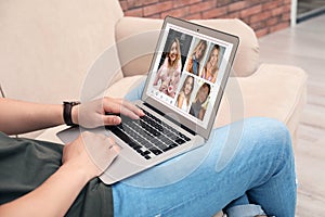 Man visiting dating site via laptop indoors, closeup