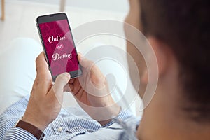 Man visiting dating site via smartphone indoors, closeup