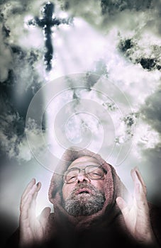 Man vocation illuminted by cross light from the clouds