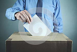 Man voting at the ballot box. Election and democracy concept photo