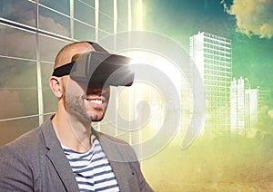 Man in VR with flares and white building graphic against window and evening sky