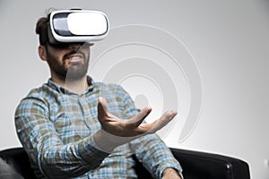 Man in vr glasses holding invisible item