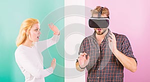 Man VR glasses involved video game while girl try to wake him up. Video game captured imagination of guy. Wife tries to