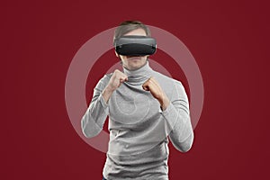 Man in VR glasses playing boxing game