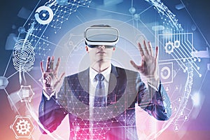 Man in VR glasses working with virtual interface