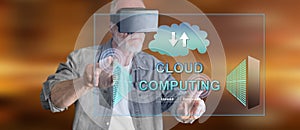 Man with VR headset touching a cloud computing concept on a touch screen