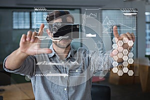 Man in VR headset touching interfaces photo