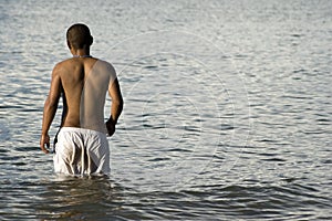 Man wading in lake or sea photo