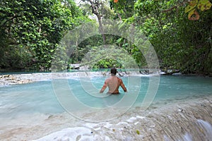 Man wading in tropical paradise pool