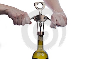 Man waiter opens a bottle of wine with corkscrew