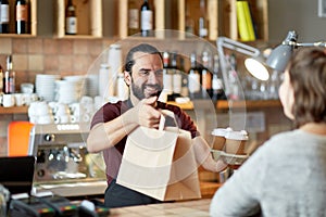 Man or waiter serving customer at coffee shop