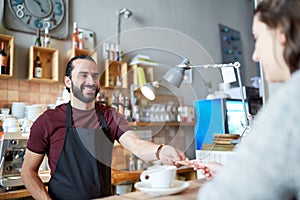 Man or waiter serving customer at coffee shop