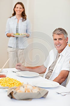 Man waiting for his wife to bring salad