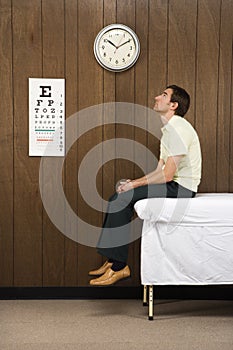 Man waiting in retro doctor's office.