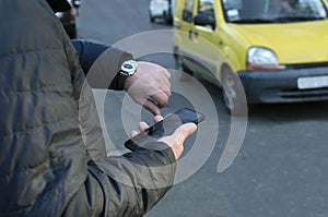 Man waiting for taxi and yellow cab riding on the road.Concept of order transfer taxi online