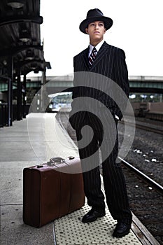 Man waiting for a train in 1940s attire