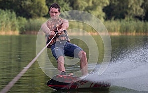 Man wakeboarder on pond in park