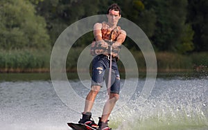 Man wakeboarder on pond in park