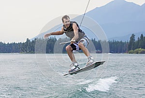 Man wakeboarding on a beautiful mountain lake