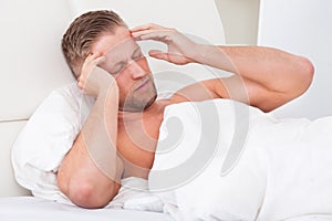 Man waking up with a nasty headache