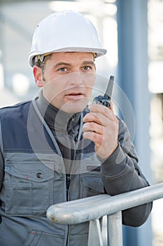 man with walkie talkie giving directions