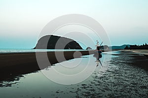 A man walking alone on the beach on holiday at KhaoSamroiyou Prachubkeereekhan Thailand .lonely alone concept idea.walking