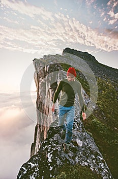 Man walking alone on the edge mountain ridge