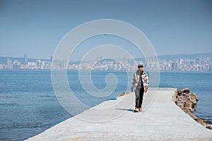 man walking alone in empty dock in the sea of marmara