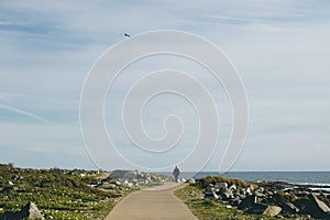 Man walking alone by the sea