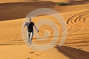 Man walking alone in the sunny desert