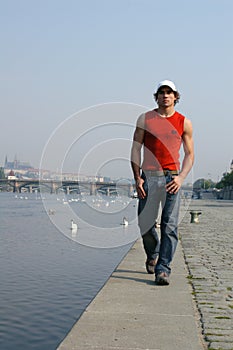 Man Walking Along the Embankment