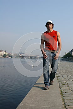Man Walking Along the Embankment