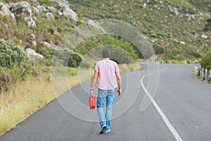 Man walking away holding petrolcan