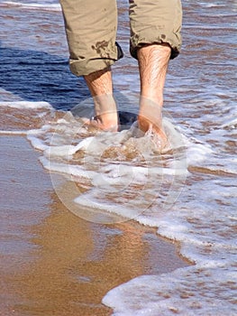 Man walking barefood on the beach