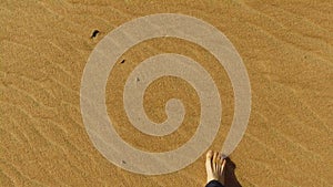 Man walking barefoot in desert