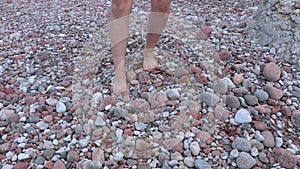 Man walking barefoot on stones