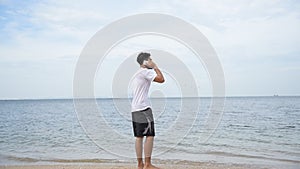 Man walking on the beach and got a call with poor signal. Telecommunication problem concept.