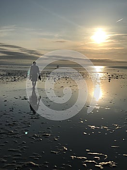 Man walking on the beach on a summer day near the ocean