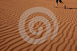 Man walking on the beautiful sand photo