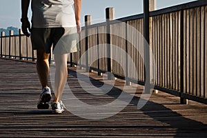 Man walking on boardwalk photo