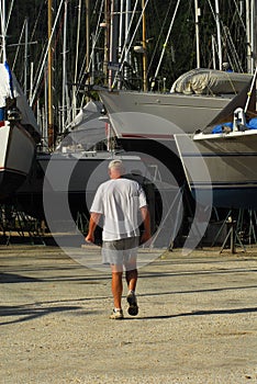 Man walking in boatyard photo