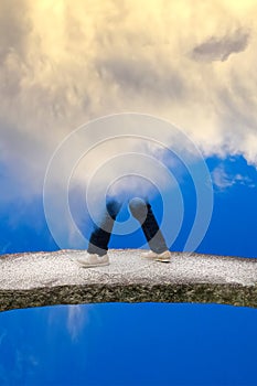 Man walking on the bridge wreathed in the clouds