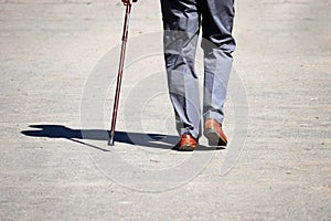 Man walking with a cane on a street