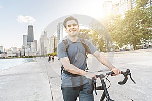 Man walking carrying his bike in Chicago