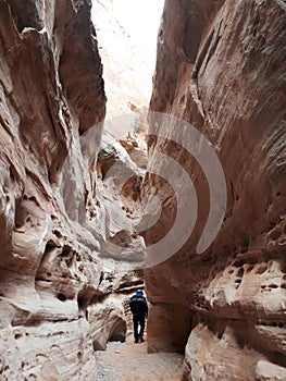 Man walking through cavern around White Rock in Valley of Fire State Park